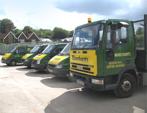 A row of five company vehicles on a sunny day 