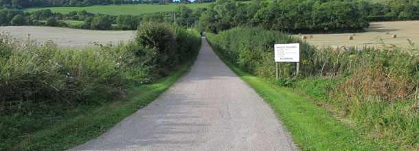 A long country road with sign 