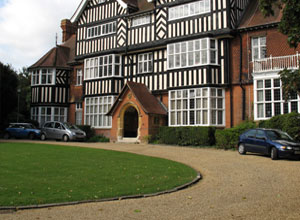 driveway leading to large tudor style building